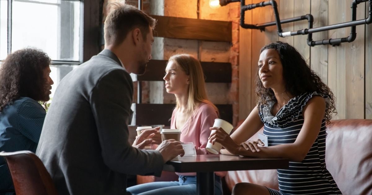 A woman listening to a man at a fun speed dating event.