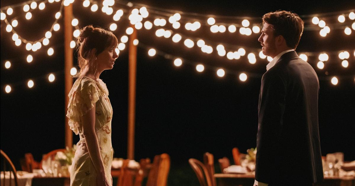 Lucy-John Lucy and John standing facing one another, in an emotional conversation