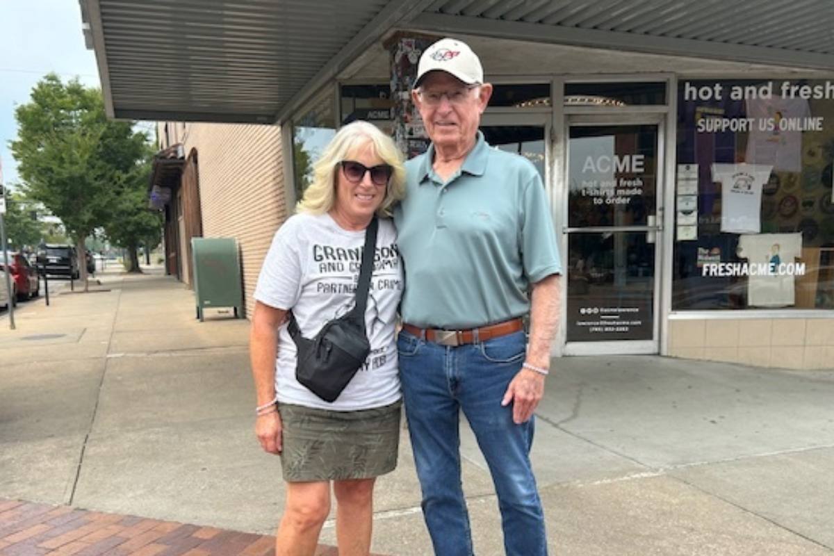 Buddy and Lorraine posing with an arm around each other.