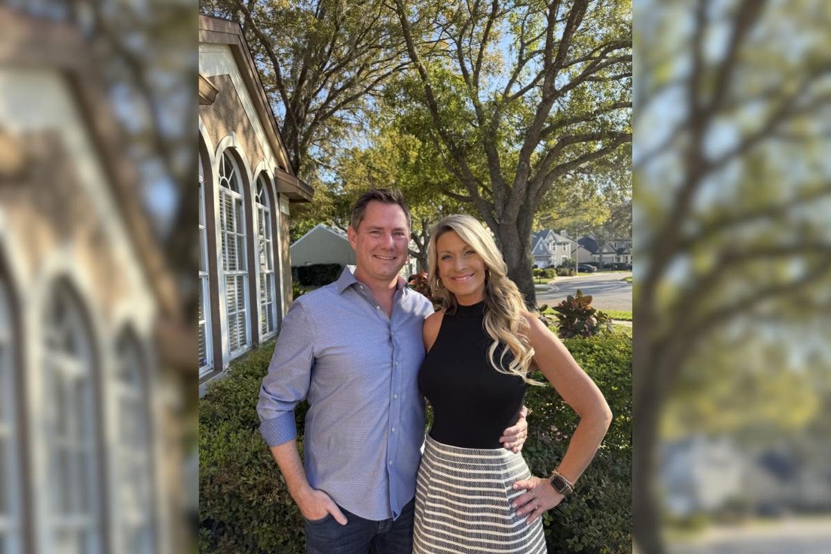 Patrick and Crystal standing arm in arm and smiling