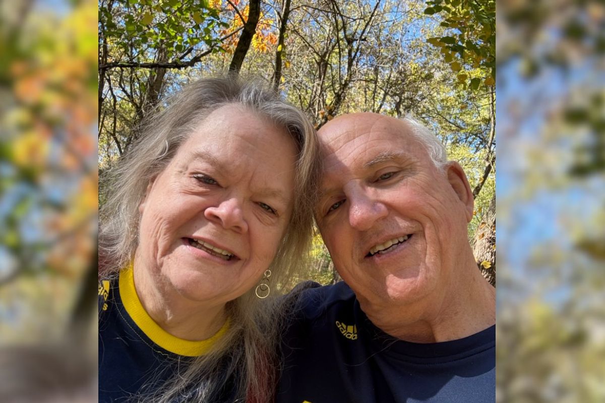 David and Theresa smiling in a selfie outdoors on a beautiful Fall day.
