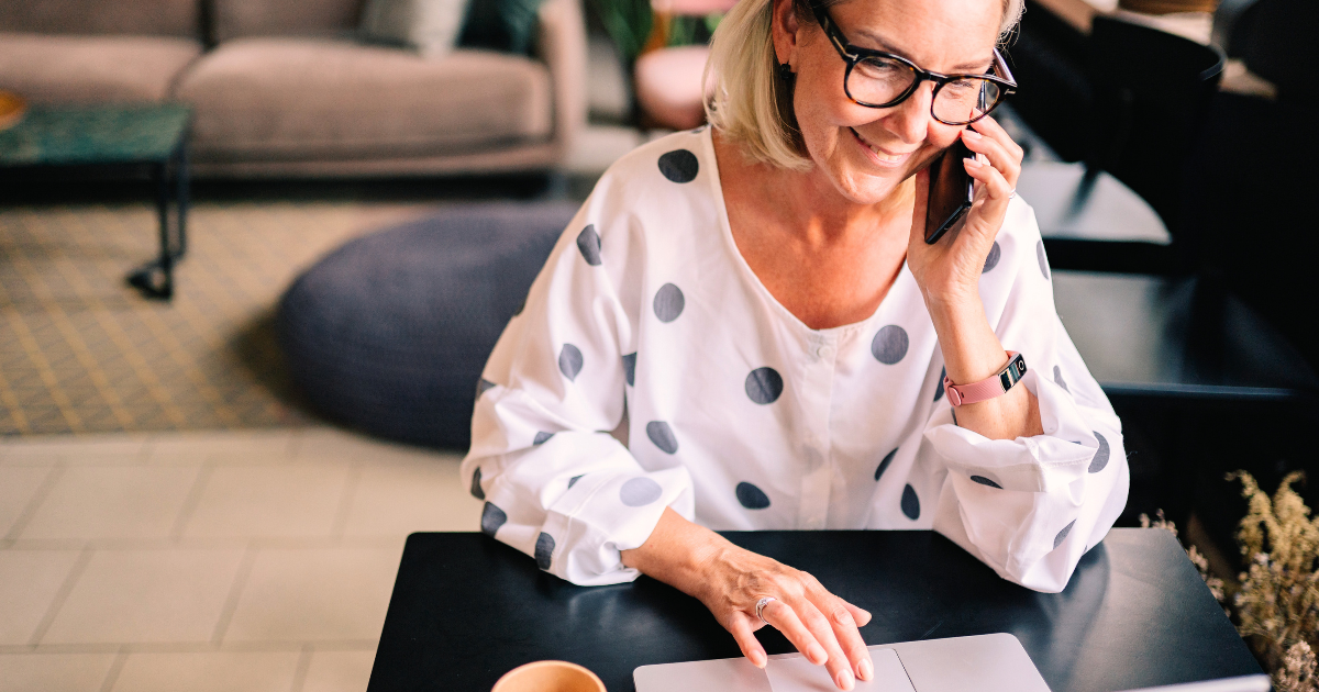 A woman talking on the phone and using a computer. She is excited to edit her online dating profiles for Dating Sunday, but how good are her chances of finding a great connection?