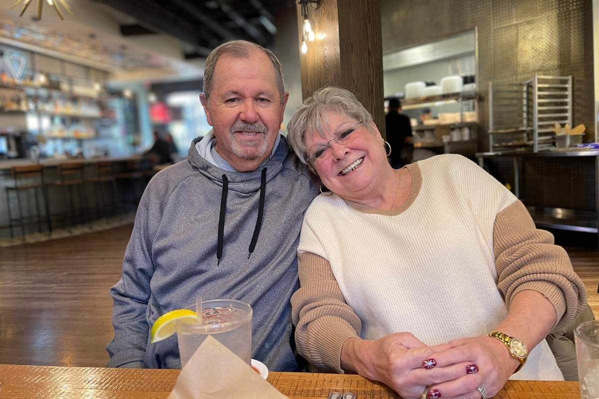 Joyful couple in their 60's who met through The Matchmaking Company out on a date at a restaurant