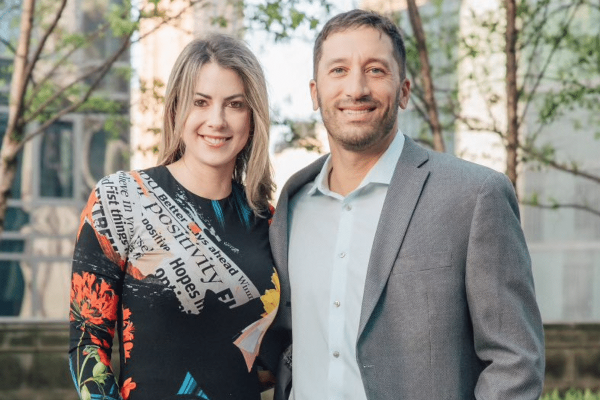 Real TMC couple Frank and Niki dressed nicely and posing with an arm around one another.