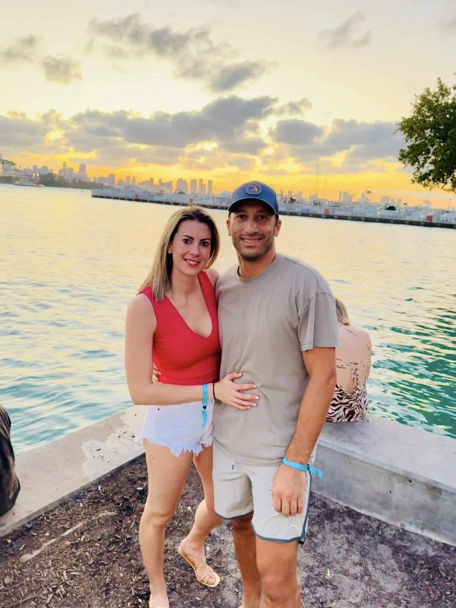 Frank and Niki posing contentedly together by the water at sunset.