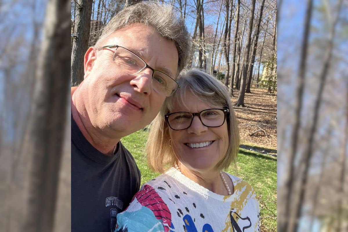Real TMC clients Brian and Joan smiling in a casual selfie outside on a sunny day.