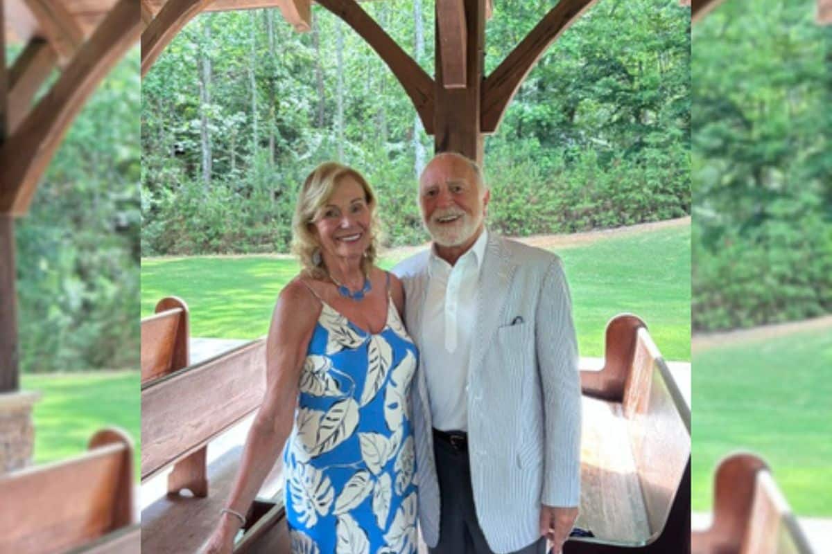 Berge and Gloria posing for a photo together in a beautiful outdoor setting.